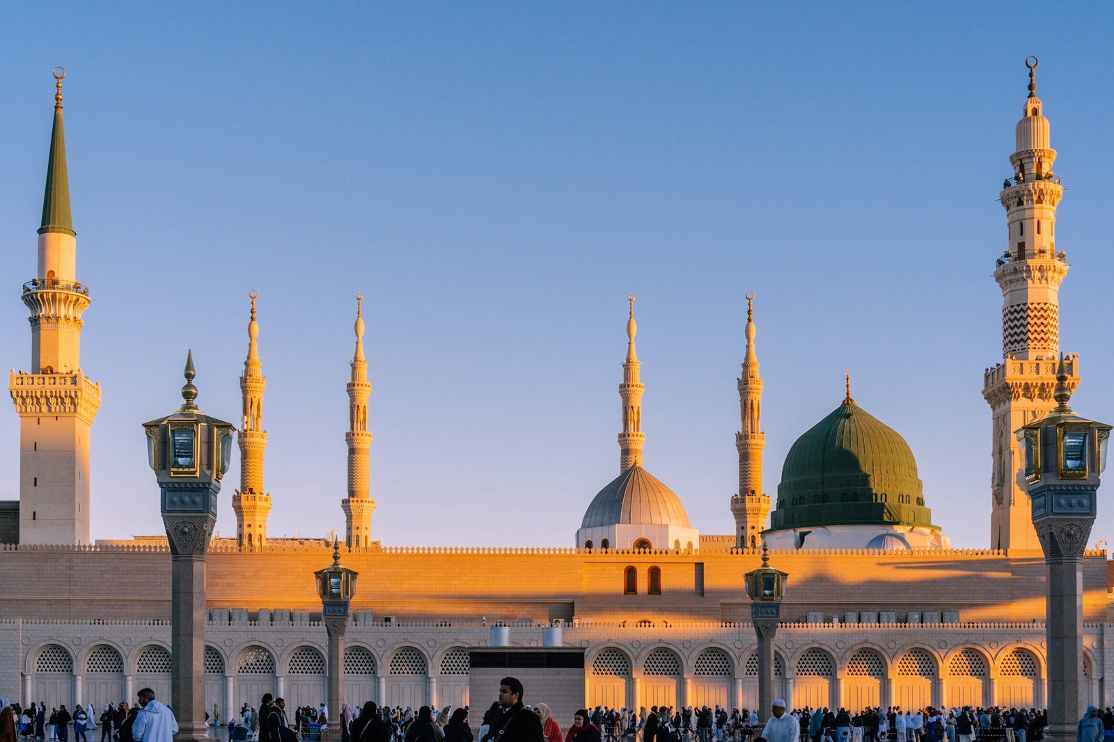 The iconic Green Dome and minarets of the Prophet's Mosque in Madinah at sunset